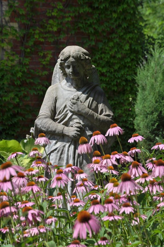 Садовая статуя среди цветов